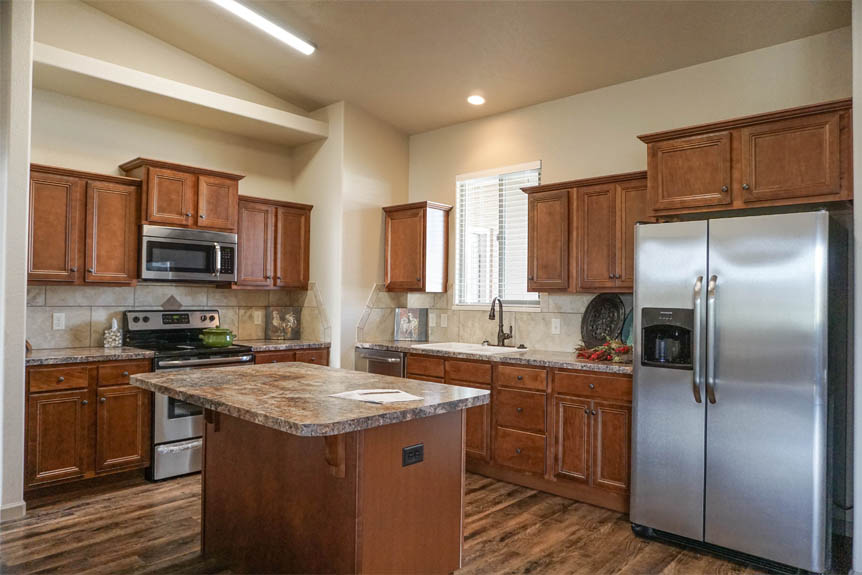 Kitchen has an island, pantry, & includes all appliances