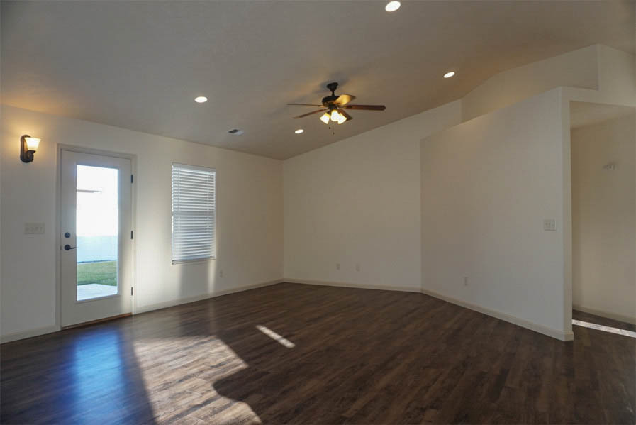 Living room has ceiling fan with light kit & access to back patio